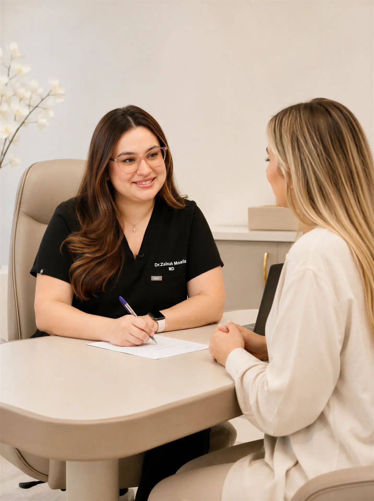 Dr. Zainab Moalla reviewing results with a patient in her Dubai clinic